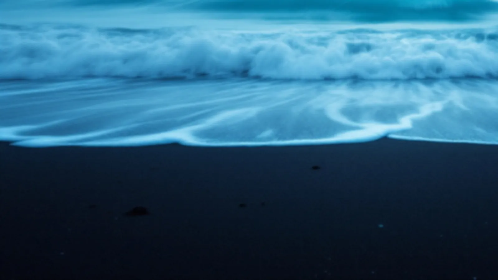 Soft blue waves on black sand, the CinderNova view of emergency cash loans online, $100 – $5,000